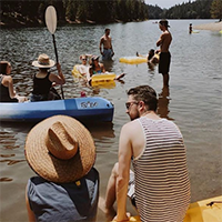 "people sitting on kayaks and canoes on a river in california"