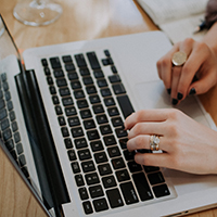 "woman's hands using a laptop"