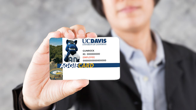 person holding aggiecard