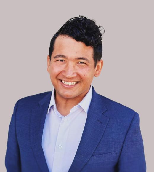 Headshot of Jordon Friend wearing a blue suit.