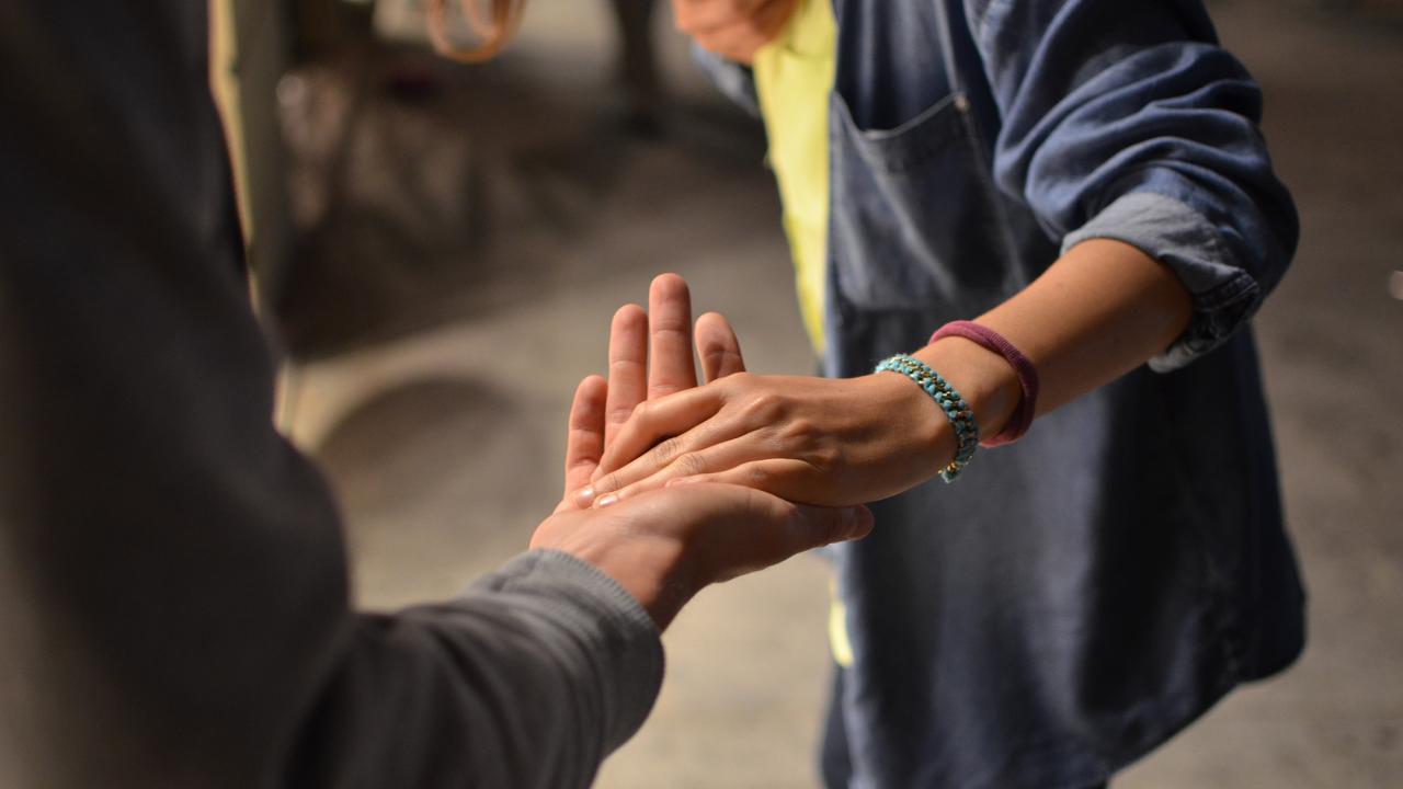 woman taking the hand of a colleague