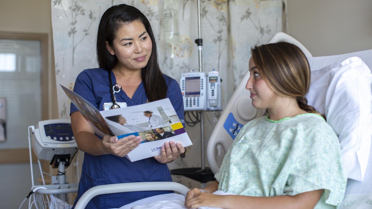 nurse discussing information with patient 