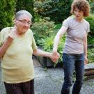 A caregiver gently supporting a patient. 