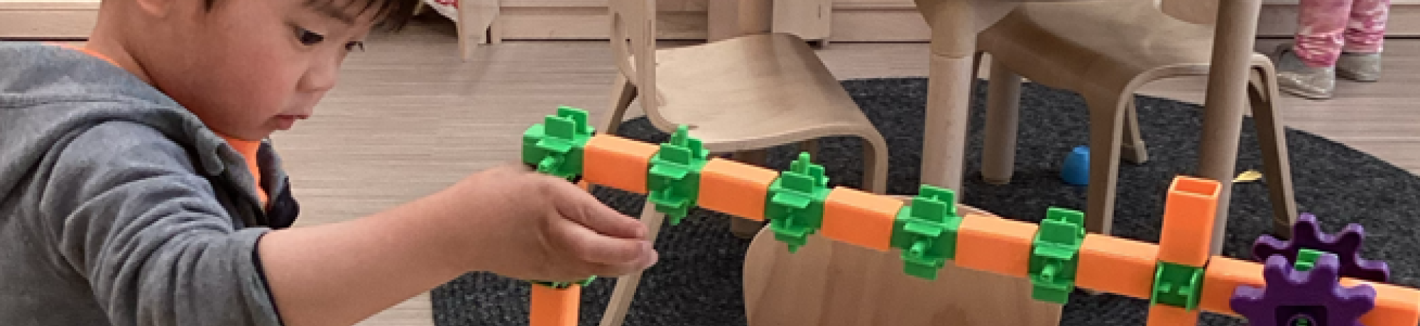 child playing with building toys